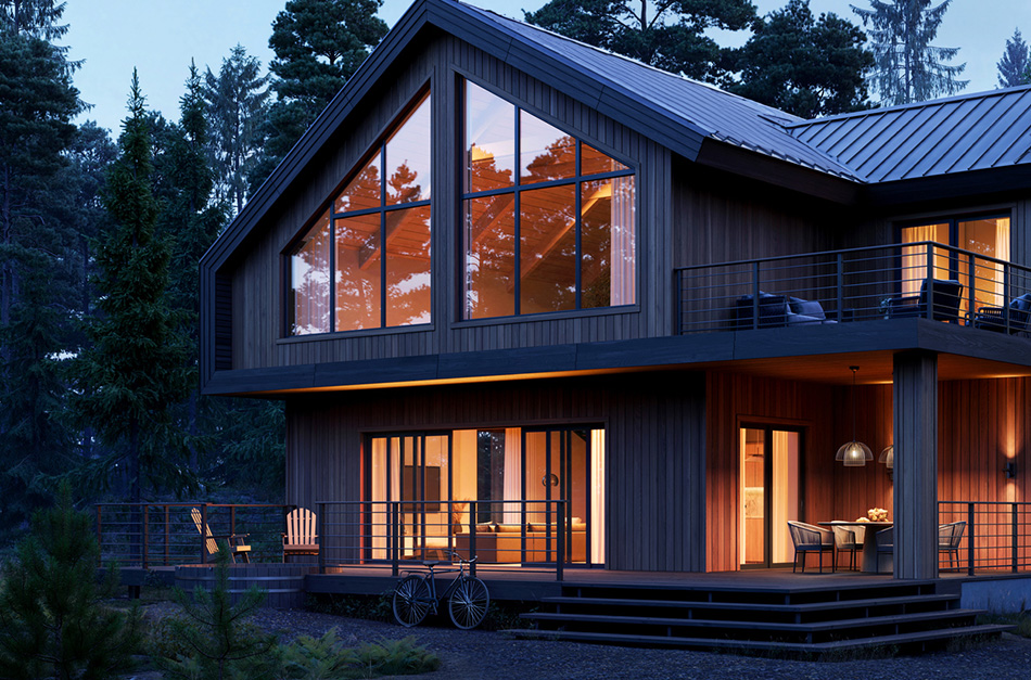 Modern house in a forest with lights on inside.